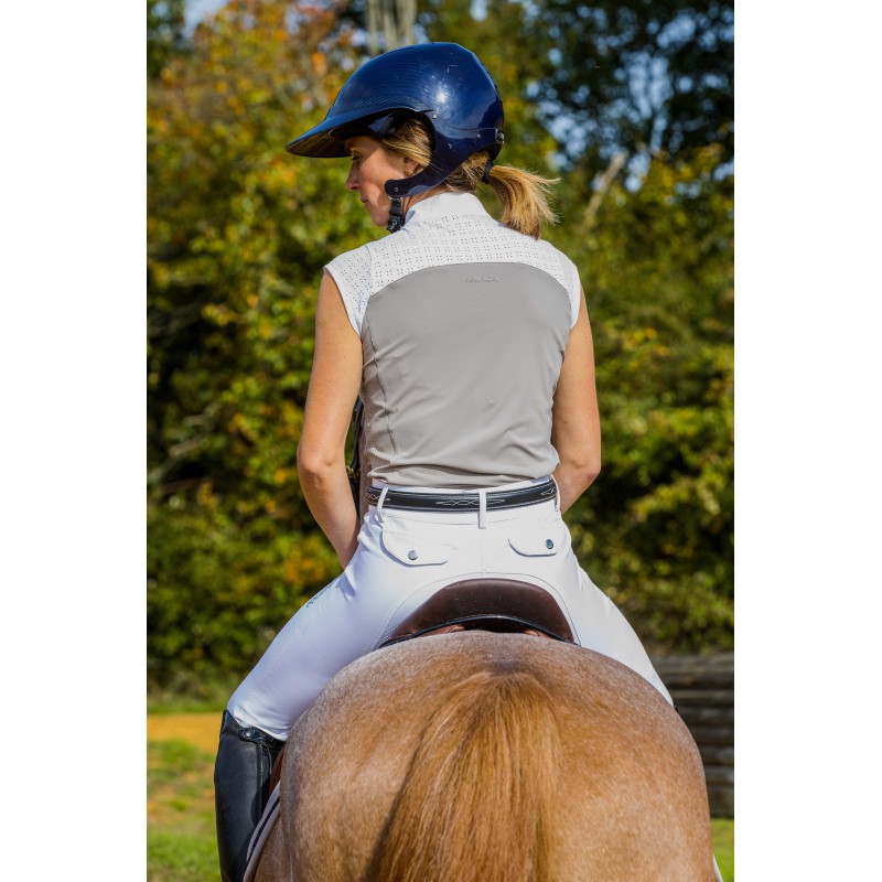 Woman on horseback wearing Judith taupe sleeveless competition shirt – back view with rhinestone detail by Equitheme