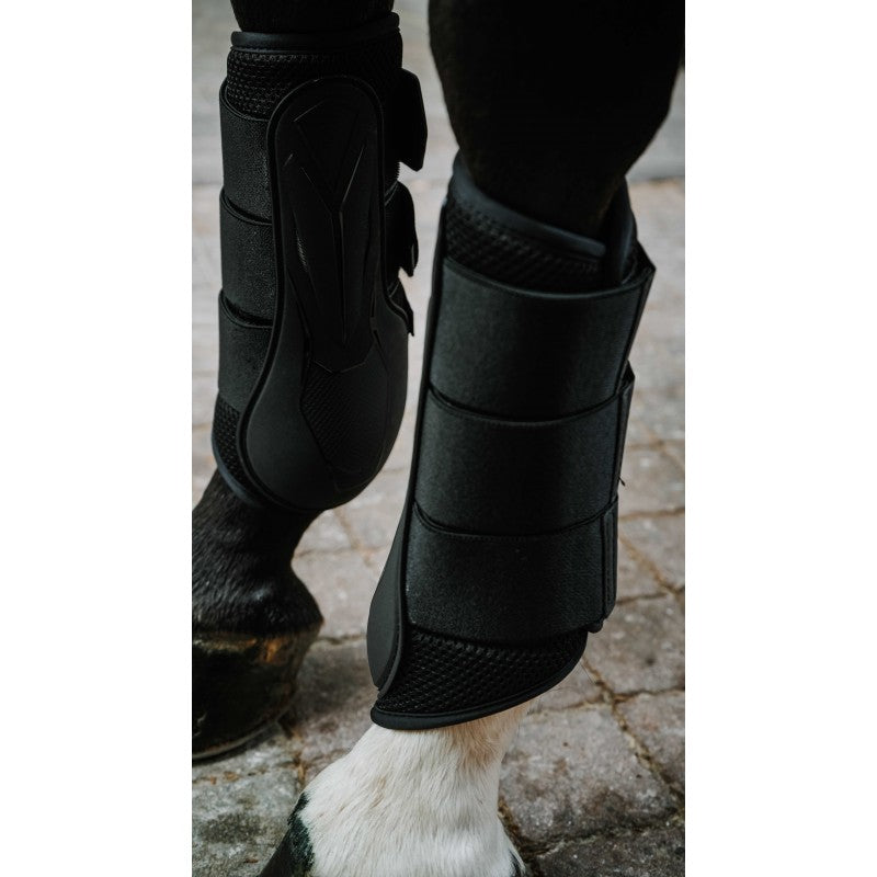 Norton XTR Flex black closed tendon boots worn on horse legs on cobblestone – ventilated horse tendon boots at Ekkivibes