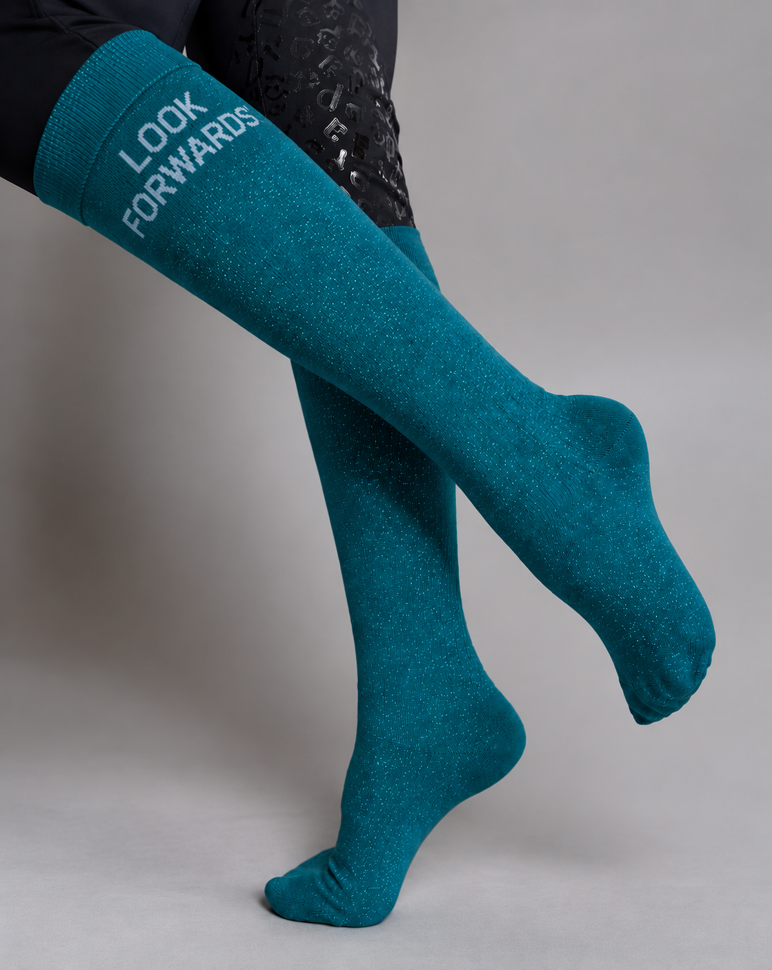 Teal glitter riding socks worn with breeches, "Look Forwards!" quote – Horse4me